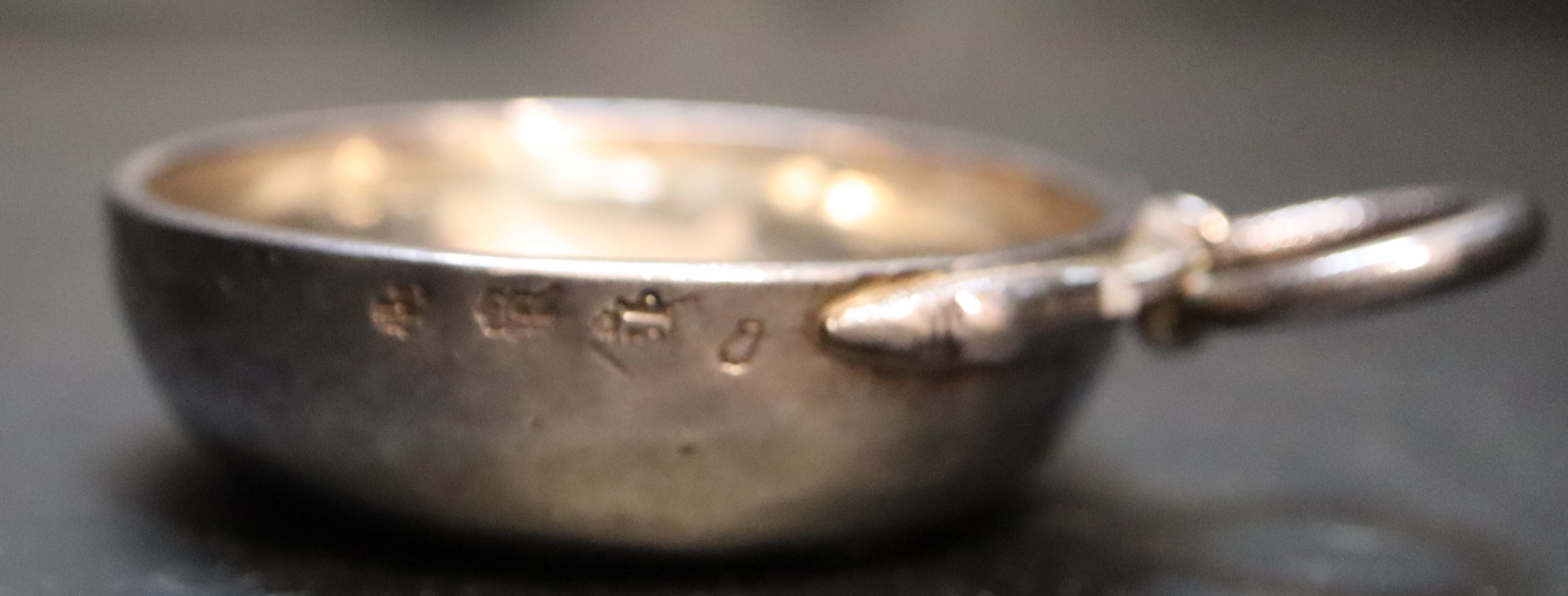 A late 18th century French white metal wine taster, diameter 7.6cm, 4oz.